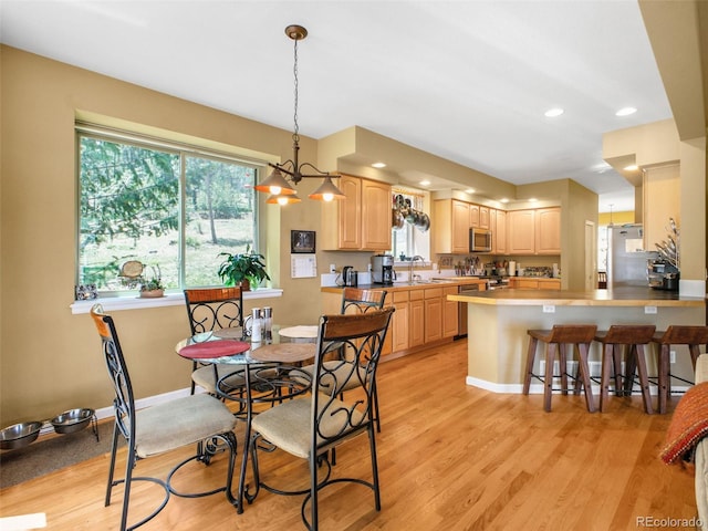 3648 Heatherwood Way, Evergreen, CO 80439 - dining area featuring light wood-style floors, plenty of natural light, recessed lighting, and a chandelier