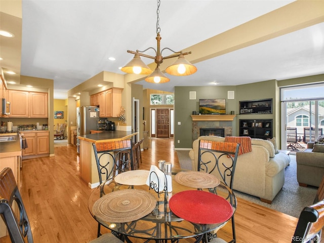 3648 Heatherwood Way, Evergreen, CO 80439 - dining area with light wood-type flooring, a glass covered fireplace, and recessed lighting