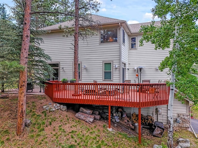 3648 Heatherwood Way, Evergreen, CO 80439 - rear view of house featuring a wooden deck and roof with shingles