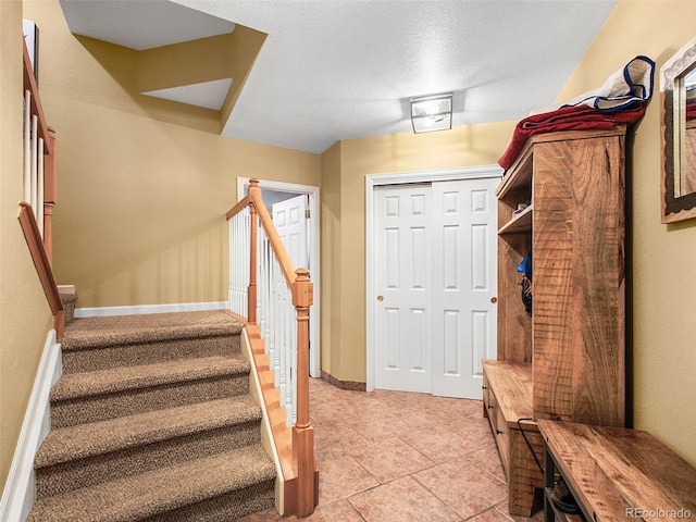 3648 Heatherwood Way, Evergreen, CO 80439 - mudroom with light tile patterned floors and baseboards