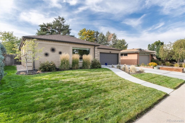 view of front of home with a front yard and a garage