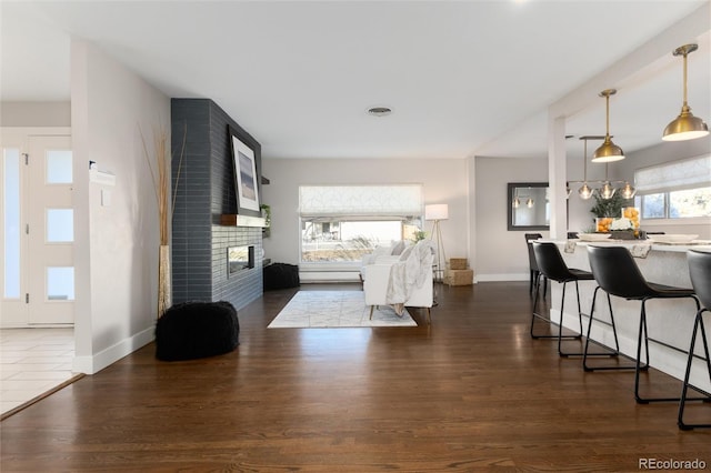 bedroom featuring dark hardwood / wood-style floors and a fireplace