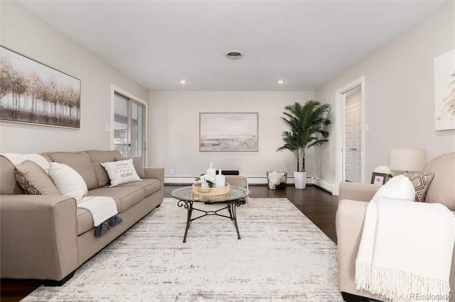 living room featuring a baseboard radiator and hardwood / wood-style flooring