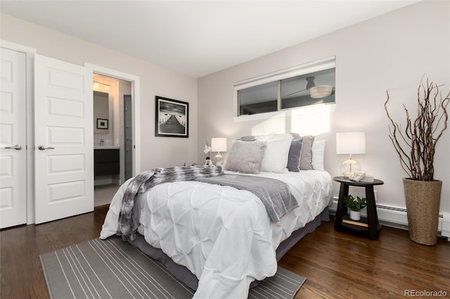 bedroom with ensuite bath and dark wood-type flooring