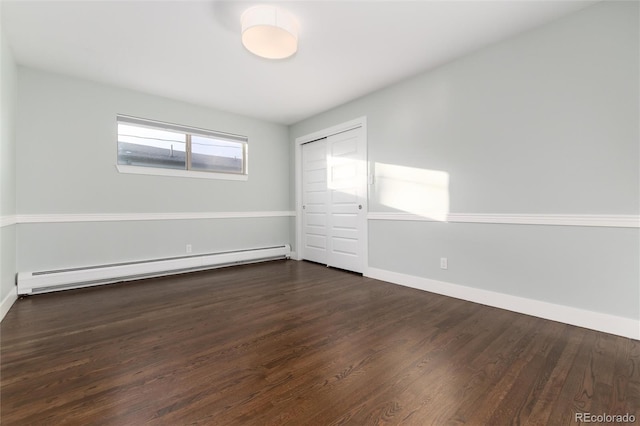 unfurnished bedroom featuring a closet, a baseboard radiator, and dark hardwood / wood-style floors