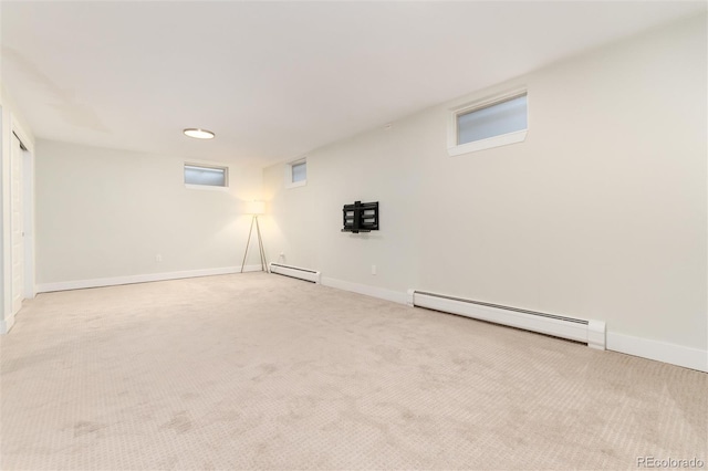 interior space with baseboard heating and light carpet