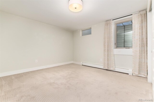 carpeted spare room with a baseboard radiator