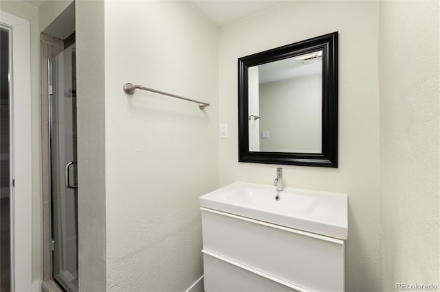 bathroom featuring vanity and a shower with shower door