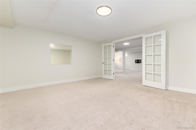 spare room with light colored carpet and french doors