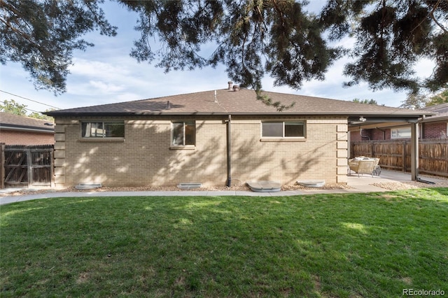 rear view of house featuring a patio and a yard