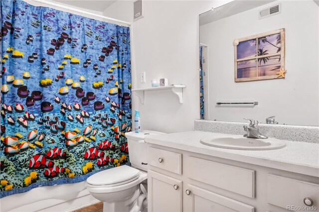 bathroom with vanity, curtained shower, and toilet