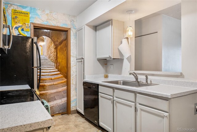 kitchen featuring sink, white cabinetry, stainless steel fridge, dishwasher, and pendant lighting