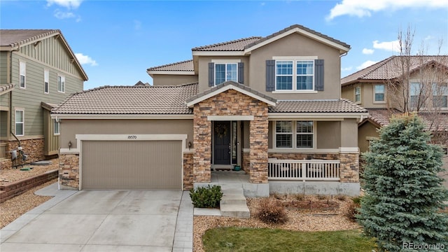 view of front facade featuring driveway, a porch, an attached garage, and stucco siding