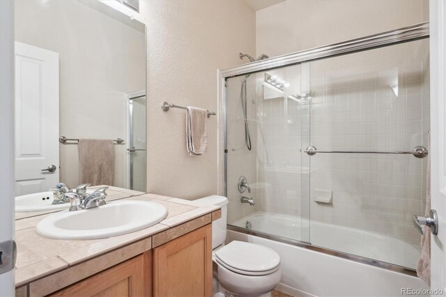 21063 E Greenwood Pl, Aurora, CO 80013 - full bathroom featuring vanity, combined bath / shower with glass door, and toilet