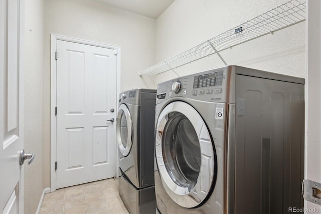 21063 E Greenwood Pl, Aurora, CO 80013 - laundry area featuring washer and clothes dryer and light tile patterned flooring