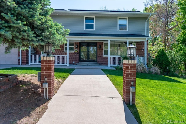 6150 Reed St, Arvada, CO 80003 - view of front of property with a porch, a front yard, and brick siding