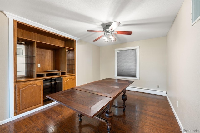 6150 Reed St, Arvada, CO 80003 - office featuring a baseboard heating unit, baseboards, dark wood-style floors, and a ceiling fan