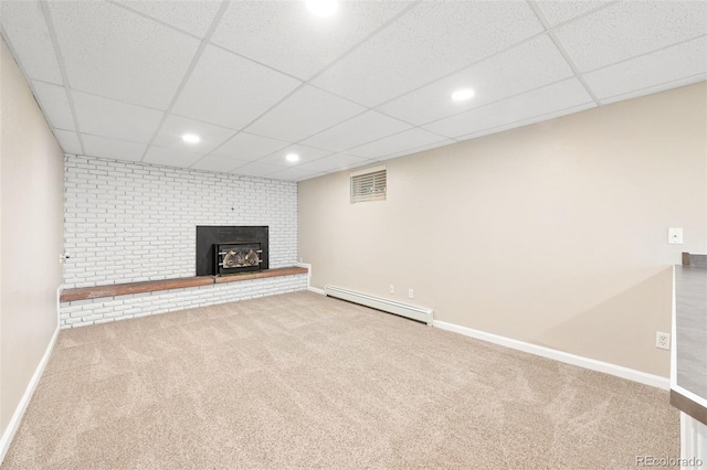 6150 Reed St, Arvada, CO 80003 - finished below grade area with a baseboard radiator, carpet, a brick fireplace, a drop ceiling, and baseboards
