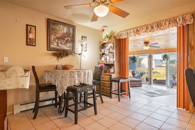 dining room with light tile patterned floors, baseboard heating, and a ceiling fan