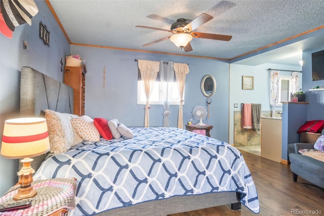 bedroom featuring a textured ceiling, wood finished floors, a ceiling fan, ensuite bath, and crown molding