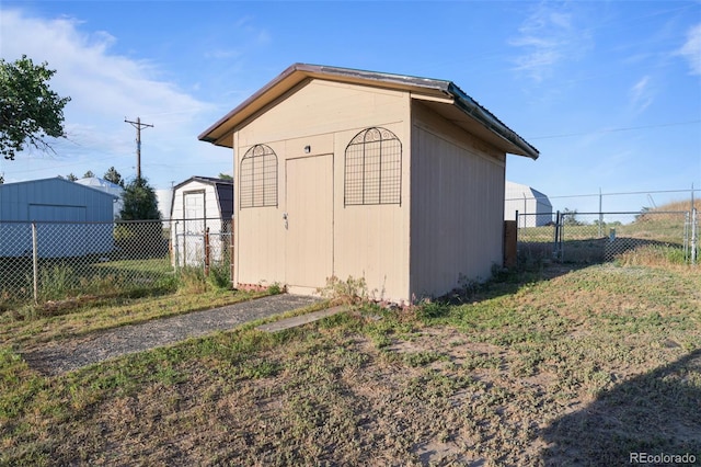 view of shed featuring fence