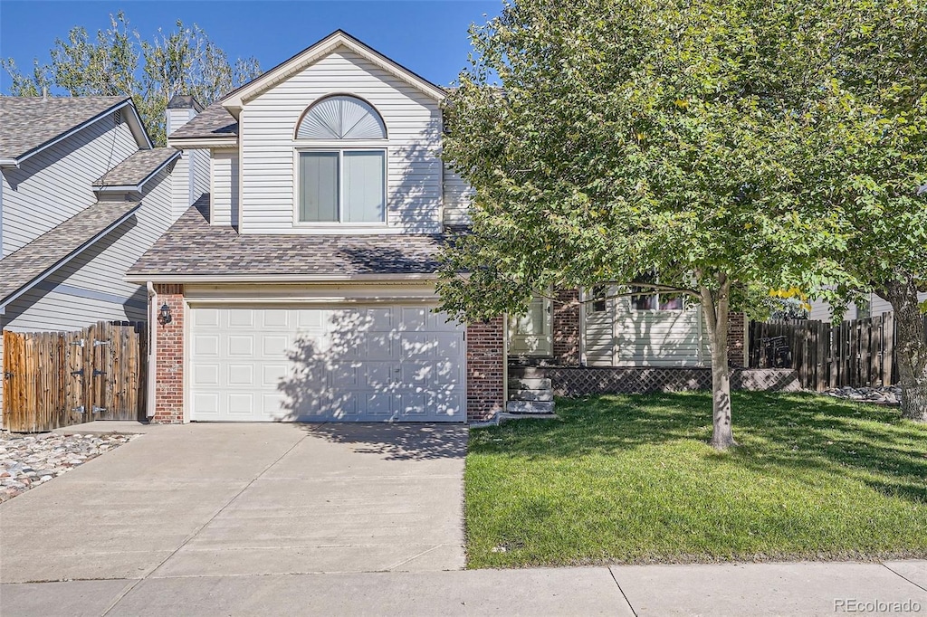 view of front of property with a garage and a front lawn