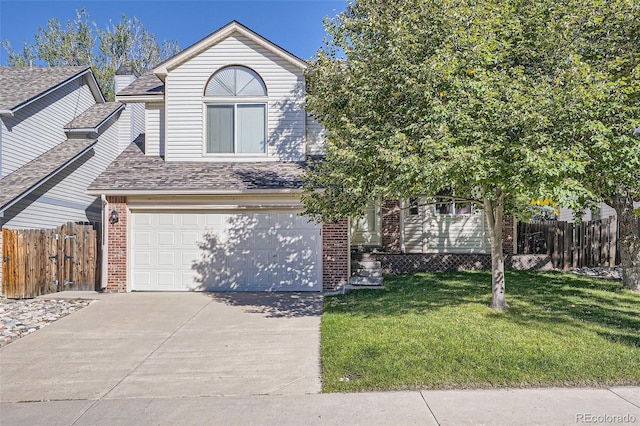 view of front of property with a garage and a front lawn