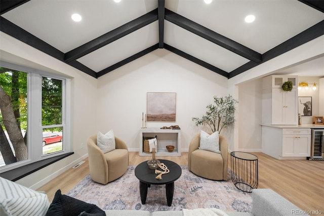 sitting room with bar, vaulted ceiling with beams, wine cooler, and light wood-type flooring