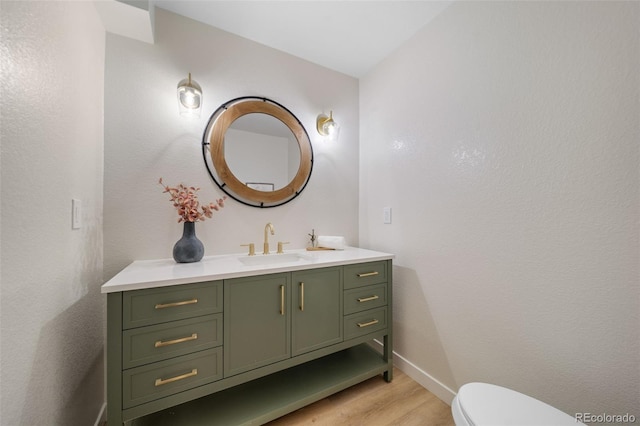 bathroom with vanity, wood-type flooring, and toilet