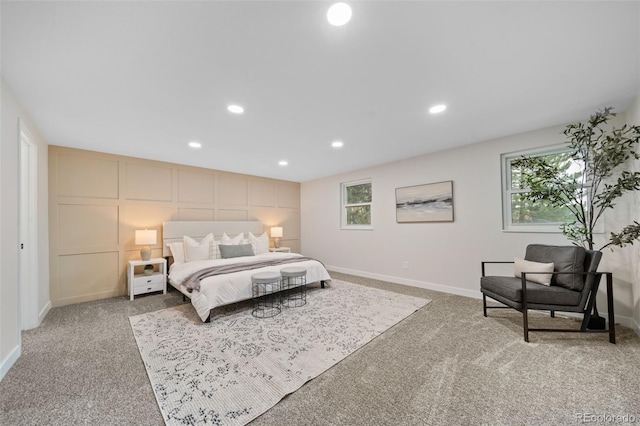 bedroom featuring multiple windows and light carpet