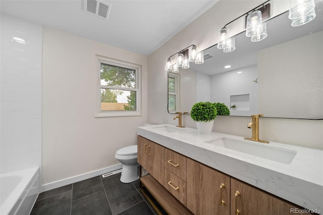 bathroom featuring vanity, tile patterned floors, and toilet