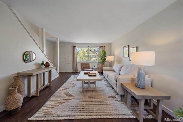 living area with baseboards and dark wood finished floors