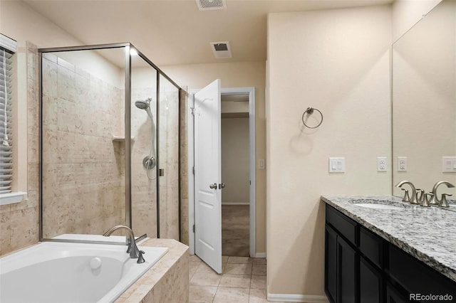 bathroom featuring tile patterned flooring, shower with separate bathtub, and vanity