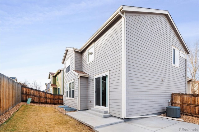 rear view of property with central AC and a patio