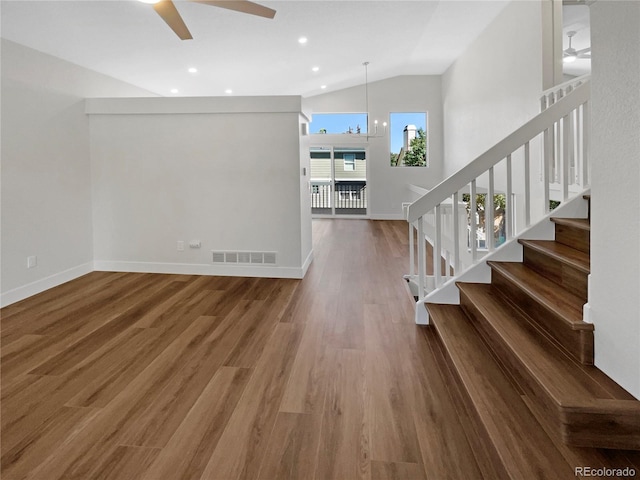 interior space with ceiling fan with notable chandelier, vaulted ceiling, and hardwood / wood-style flooring