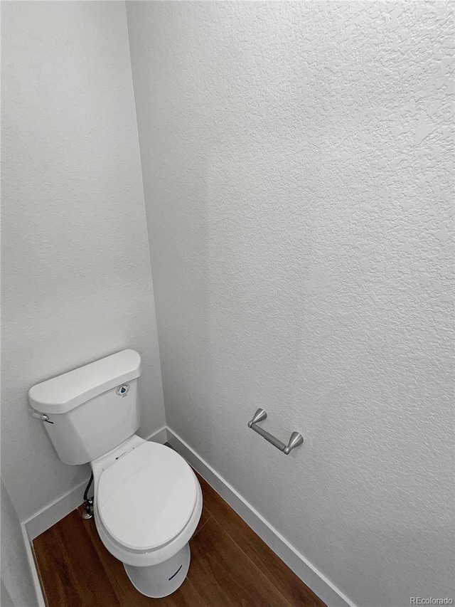 bathroom with toilet and hardwood / wood-style flooring