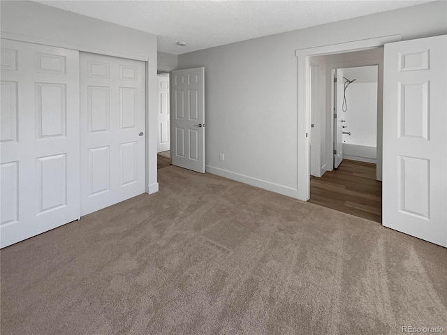 unfurnished bedroom with a closet, carpet floors, and a textured ceiling