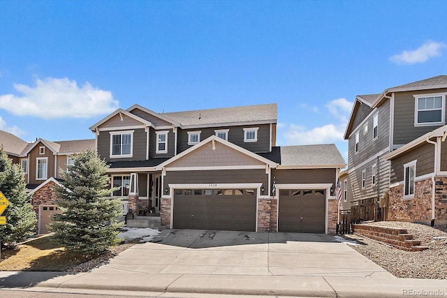 craftsman inspired home with concrete driveway, a garage, and stone siding