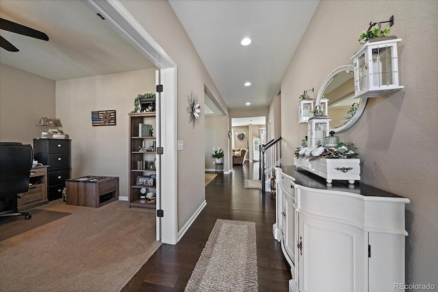 corridor featuring stairs, recessed lighting, baseboards, and dark wood-style flooring