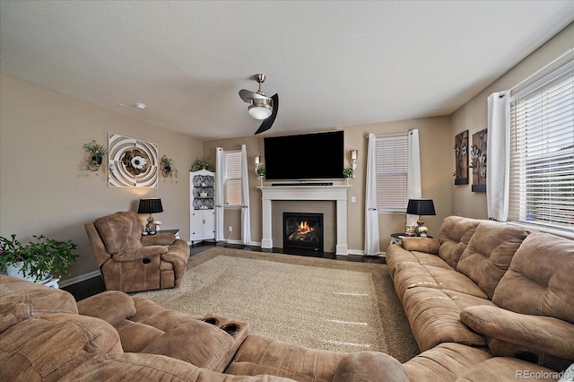 living room with baseboards and a fireplace with flush hearth