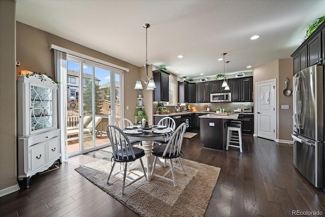 dining area featuring dark wood-style floors, recessed lighting, and baseboards