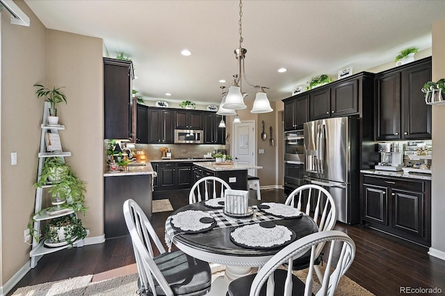 dining space featuring dark wood-style floors, recessed lighting, and baseboards