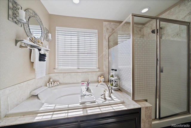 bathroom with a shower stall and a bath