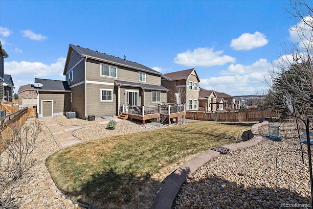 back of house with a lawn, a deck, central AC, a fenced backyard, and a residential view