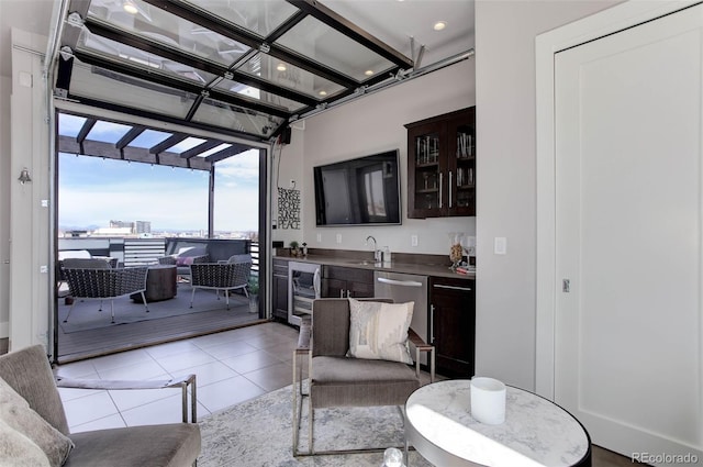 2442 Champa St, Denver, CO 80205 - living area featuring beverage cooler, bar with sink, light tile patterned floors, and floor to ceiling windows