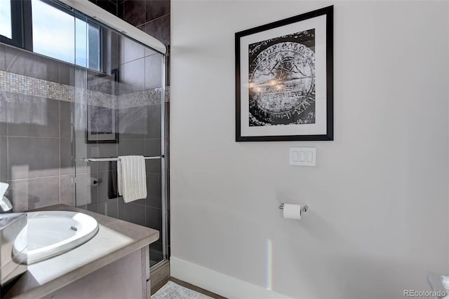 2442 Champa St, Denver, CO 80205 - bathroom with a shower stall, vanity, and baseboards