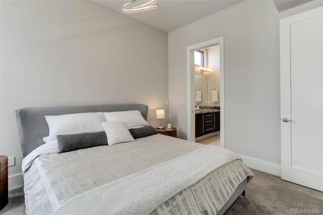 2442 Champa St, Denver, CO 80205 - bedroom featuring light colored carpet, baseboards, and ensuite bath