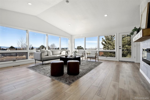 living room featuring light hardwood / wood-style flooring and vaulted ceiling