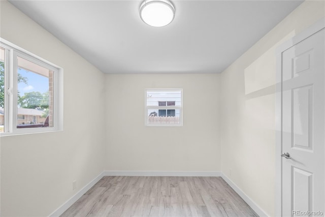 unfurnished room featuring light wood-type flooring and plenty of natural light