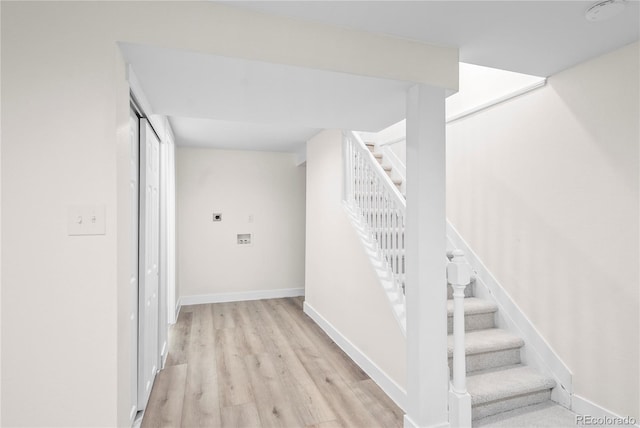 stairway with hardwood / wood-style floors